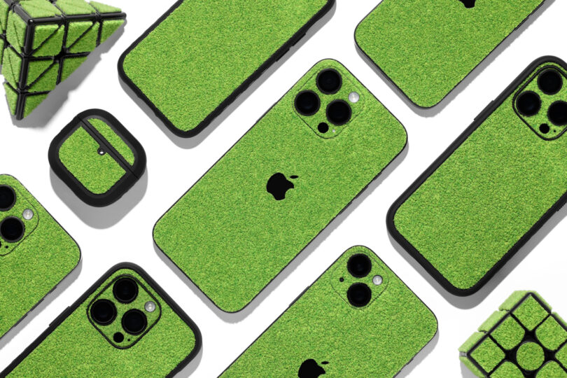 Multiple iPhones, AirPods, and a Rubik’s cube are covered in green grass-like textured cases, arranged on a white background.