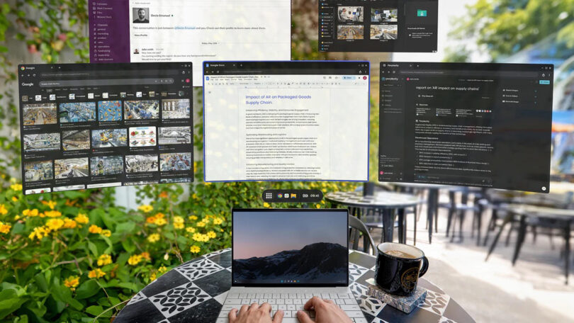 A person types on a laptop at an outdoor café table with a coffee cup; multiple digital browser and application windows are displayed above the laptop.