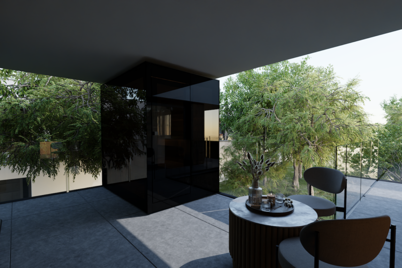 A modern balcony with glass railings, a round table set with a tray, two chairs, and trees visible in the background