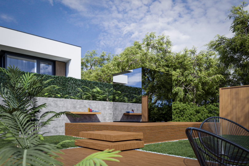 Modern outdoor patio with wooden deck, built-in seating, green hedges, tall trees, and a contemporary building in the background under a partly cloudy sky