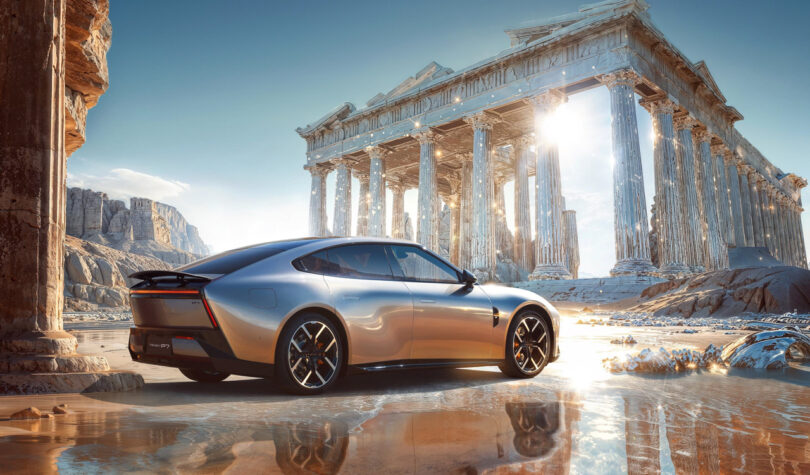 A sleek silver XPeng P7 sports car parked beside ancient Greek ruins with tall columns under a bright, clear sky.