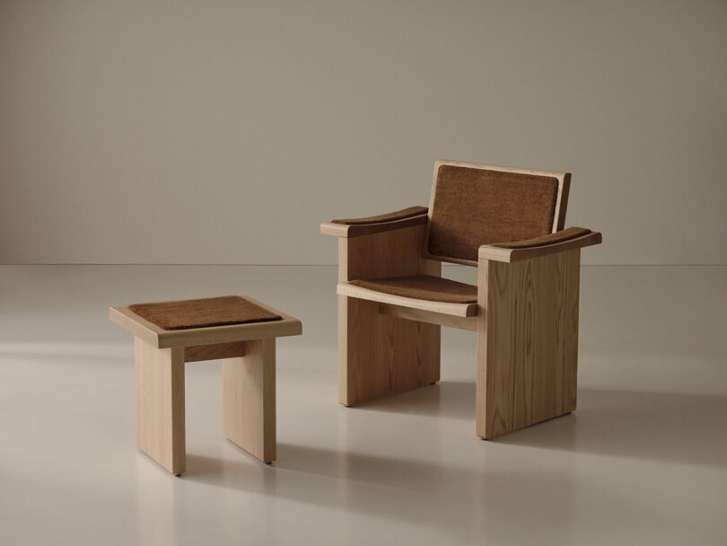 The wooden chair with brown seats and backleads are placed next to the appropriate wooden chair in a minimalist room with a neutral background.