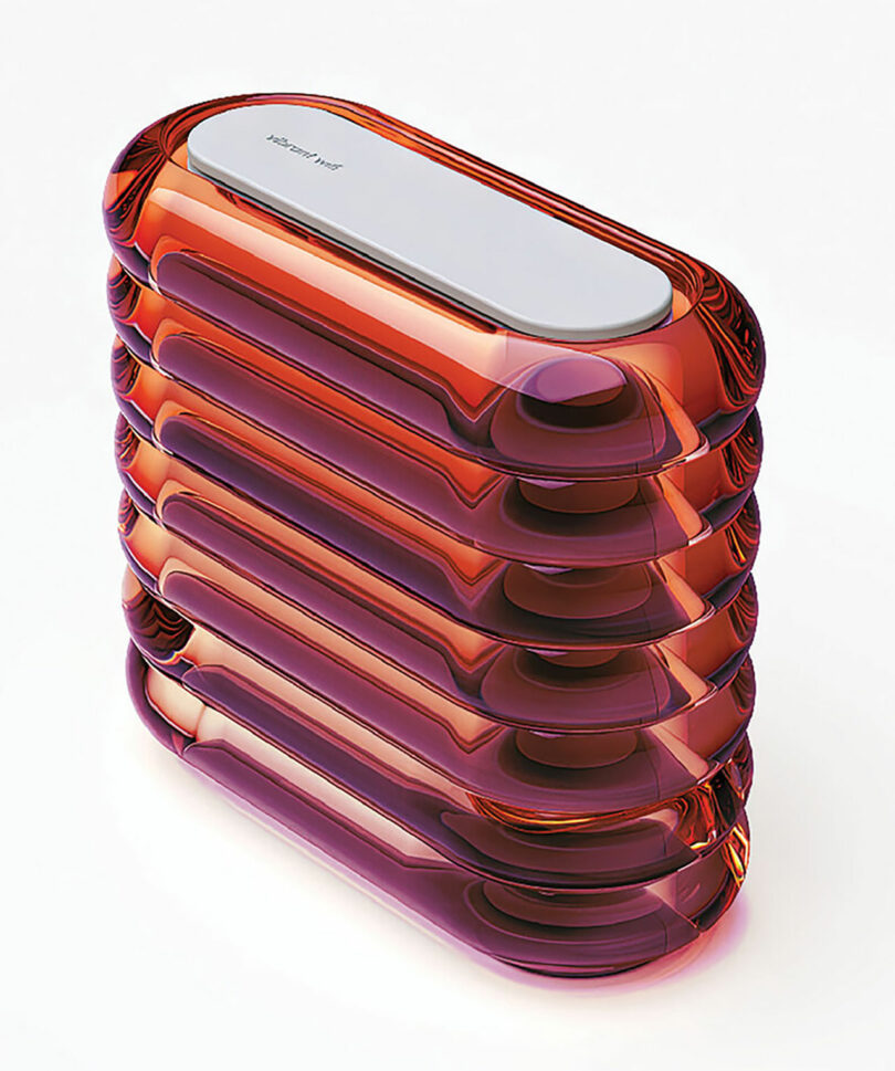 Stacked, translucent, oval-shaped reddish-orange glass blocks with a smooth, silver metallic top create a vibrant look against a light background.
