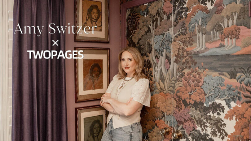 A woman stands with arms crossed in a decorated room with framed portraits and patterned wallpaper, showcasing the unique style of TWOPAGES. Text reads "Amy Switzer x TWOPAGES."