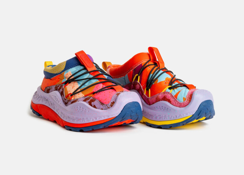 A pair of colorful, low-top sneakers with multicolored panels, patterned laces, and thick, textured soles on a white background