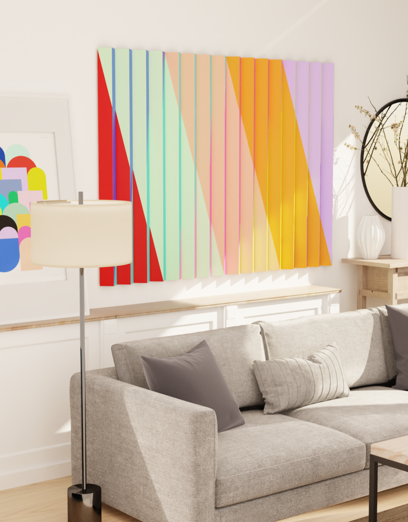 A modern living room with a gray sofa, two gray pillows, a floor lamp, and colorful geometric wall art above the couch