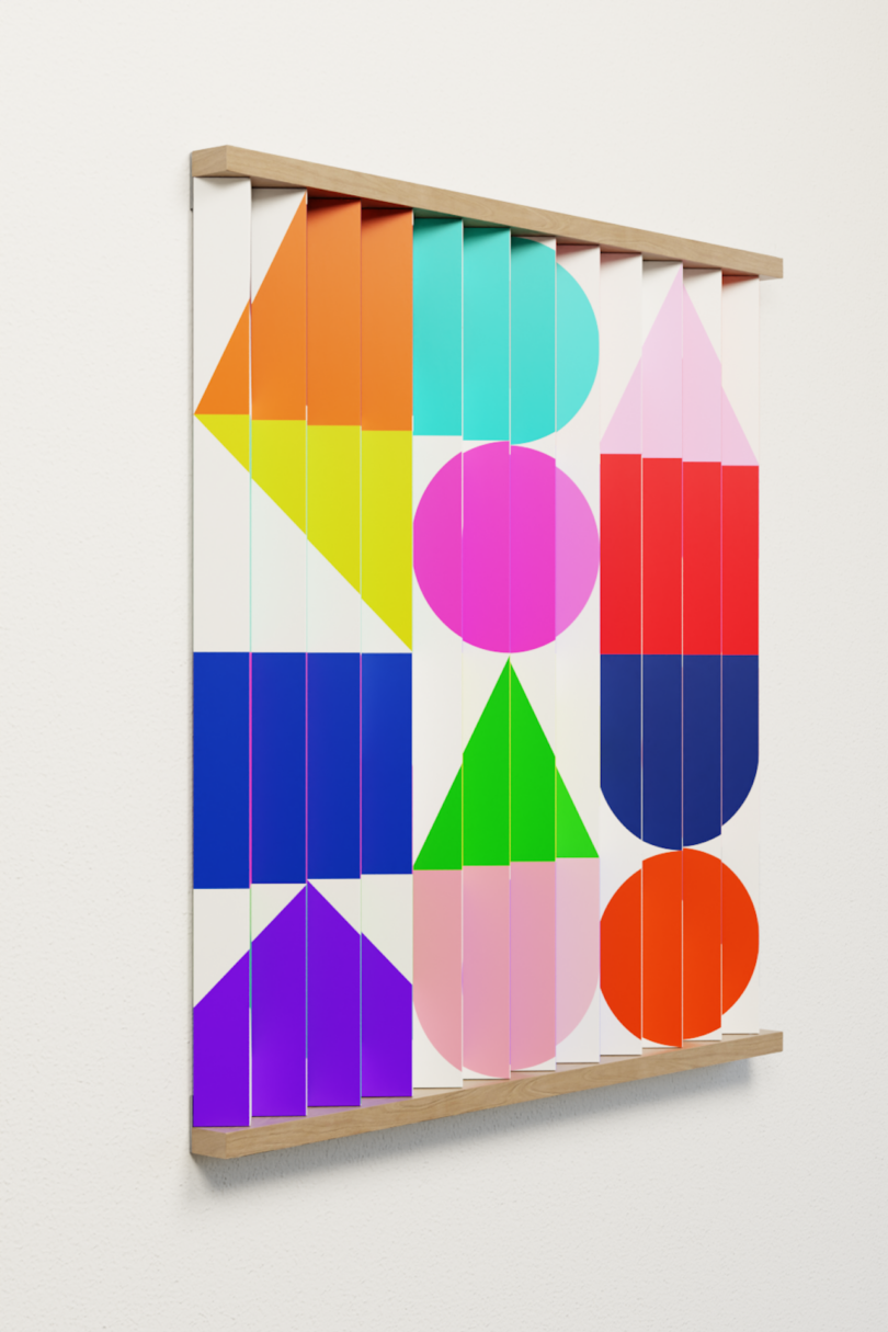 Rectangular wall art with colorful geometric shapes, including circles, triangles, and rectangles, arranged vertically on separate panels in a wooden frame against a white wall