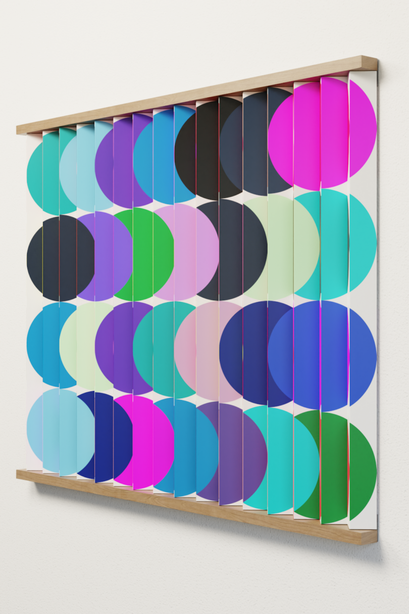 A wall art piece featuring vertical slats with colorful overlapping circles in pink, blue, green, purple, and black tones mounted on a white wall