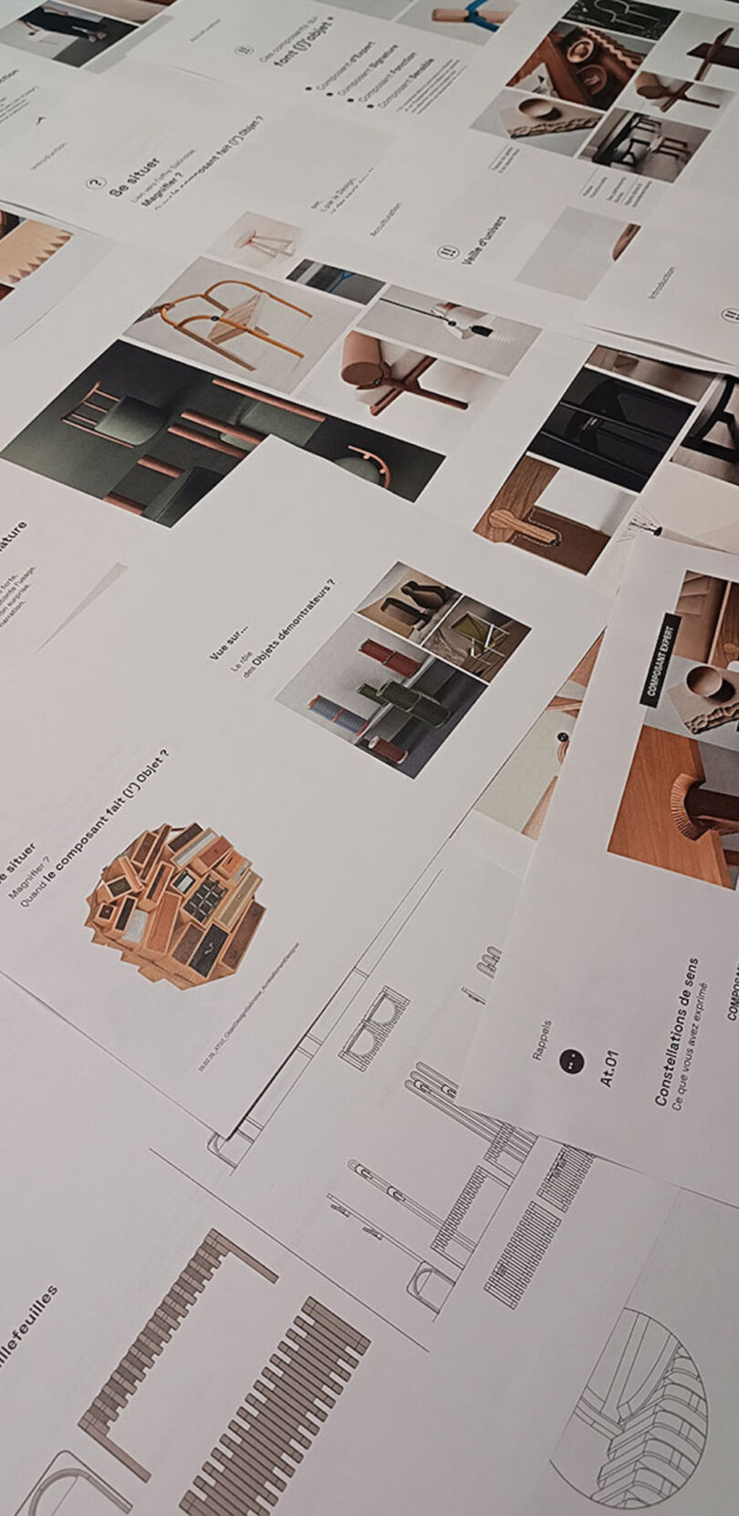 Printed pages with images and descriptions of various furniture pieces are spread out on a flat surface