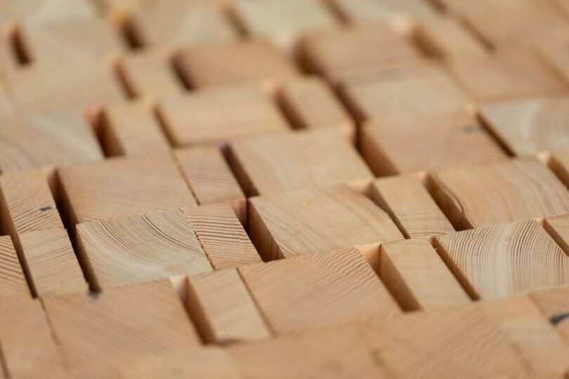 Close-up of a geometric arrangement of wooden blocks with varying heights and visible wood grain patterns