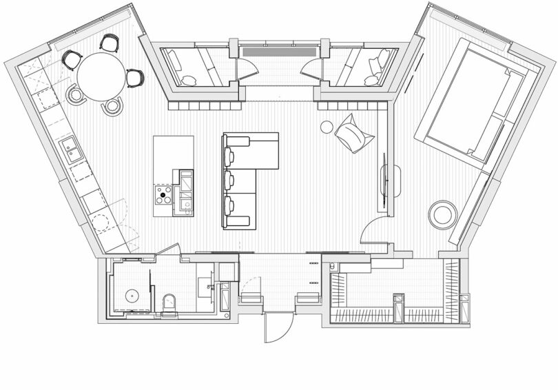 Architectural floor plan of an open-concept apartment featuring a kitchen, dining area, living room, bedroom, bathroom, and entryway.