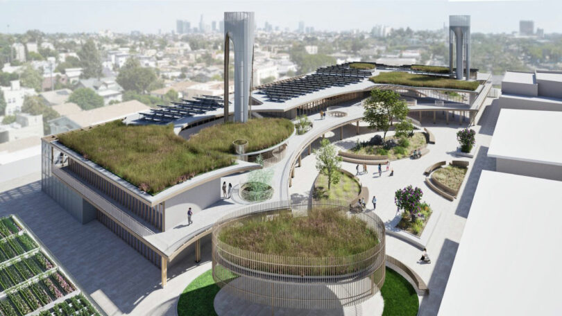 Aerial view of a modern building designed by Tyler Kobick with green roofs, curved walkways, rooftop gardens, solar panels, and people walking; cityscape visible in the background.