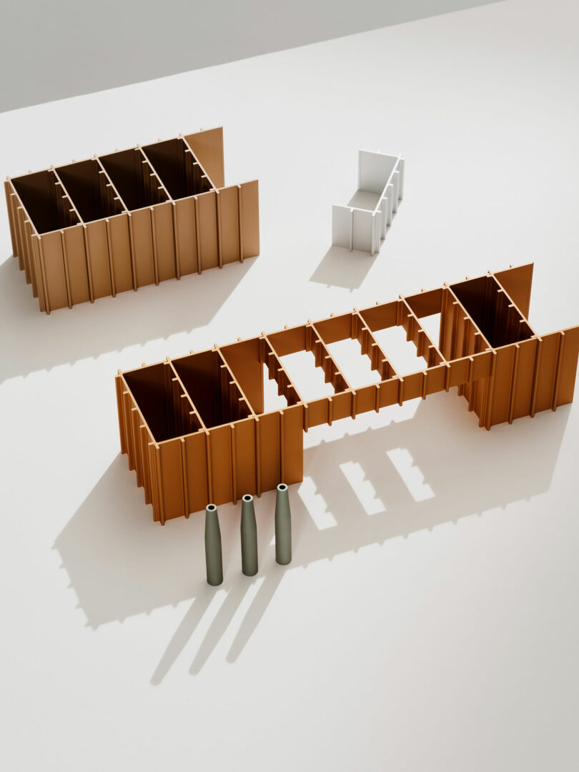 A minimalist scene features two large brown rectangular structures, one smaller white structure, and three upright gray cylinders casting shadows on a light surface.