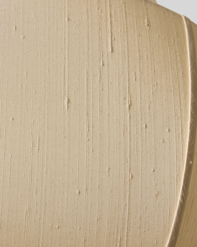 Close-up of a smooth, creamy substance with visible Workstead-inspired brush or spatula marks and tiny air bubbles, possibly a cosmetic product or food item, in a beige or light tan color.