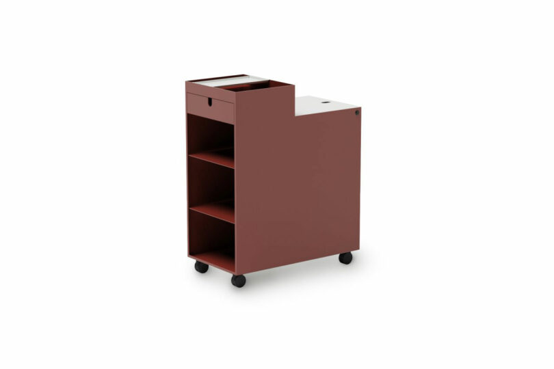 A rectangular, reddish-brown mobile storage cart with three open shelves, a closed drawer, and caster wheels, shown on a white background.