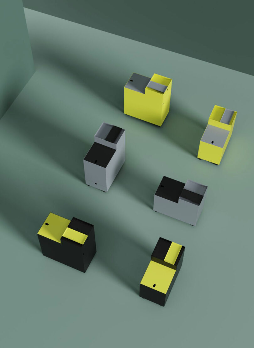 Six rectangular, interlocking blocks in yellow, black, and gray are arranged on a flat surface, casting angled shadows against a muted green background.