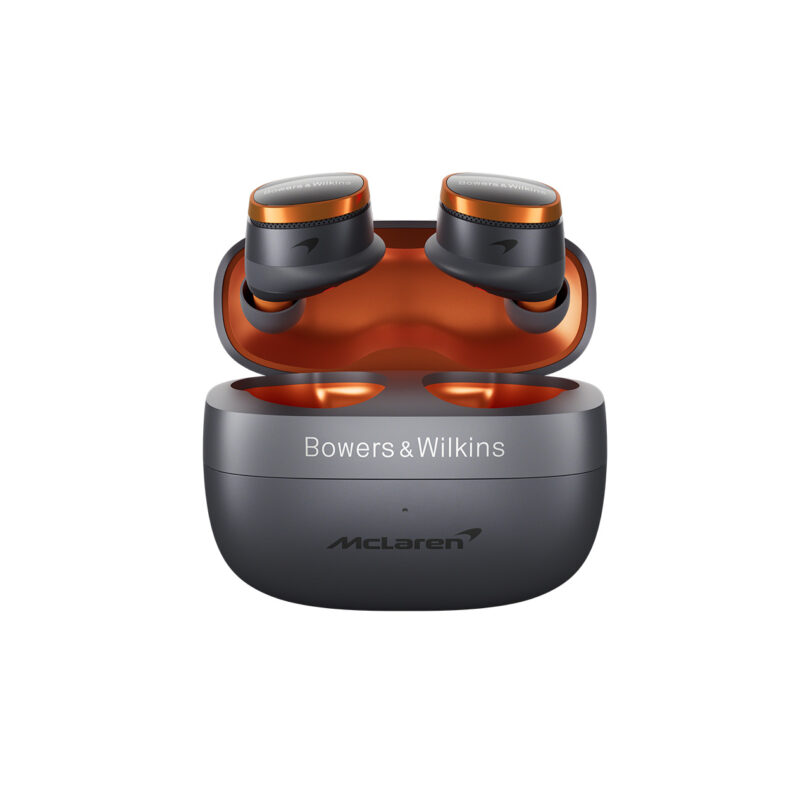 A pair of black and orange Bowers & Wilkins wireless earbuds in an open charging case with McLaren branding.