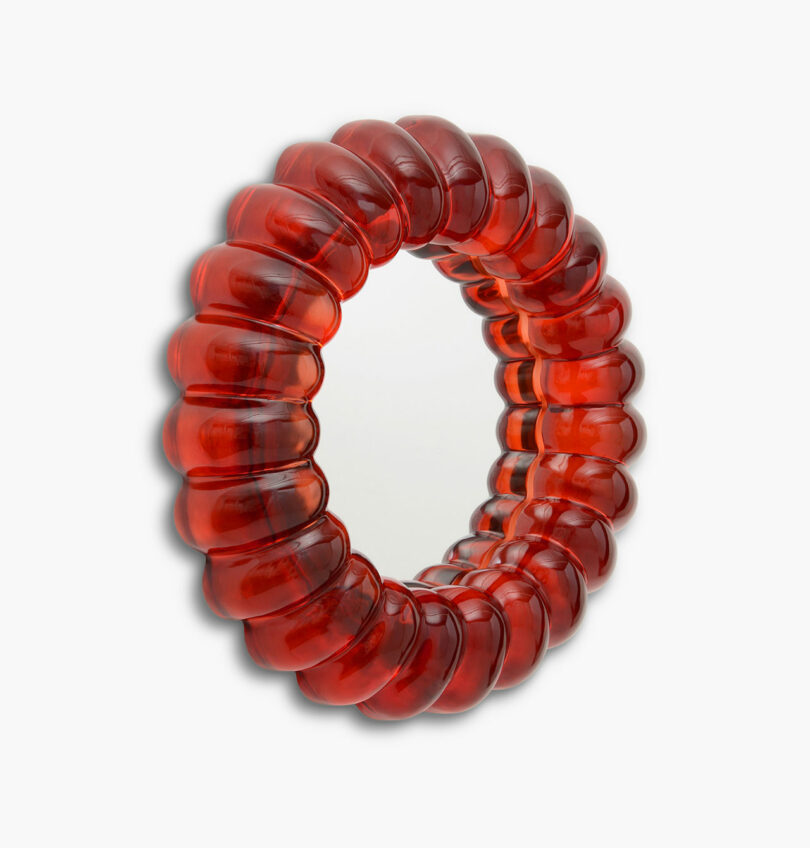 close up of red resin mirror reminiscent of jelly
