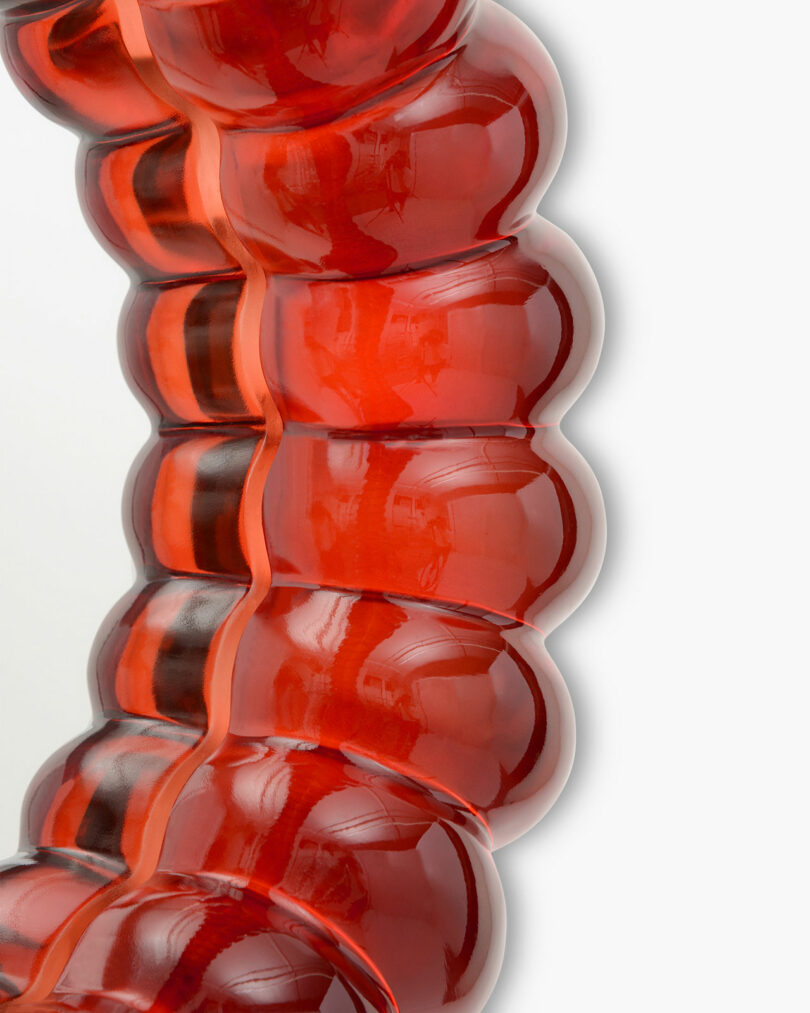 close up of red resin mirror reminiscent of jelly