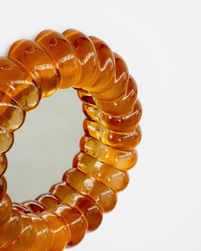close up of orange resin mirror reminiscent of jelly