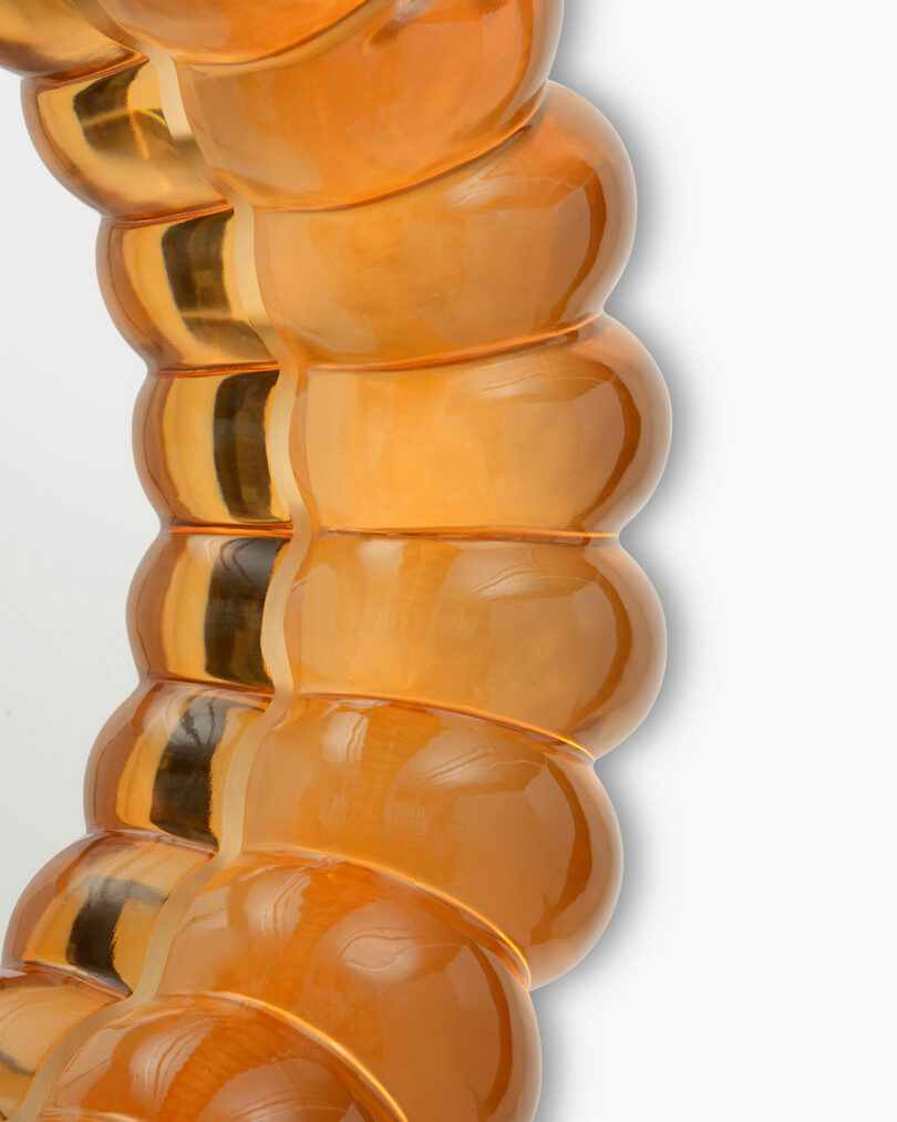 close up of orange resin mirror reminiscent of jelly