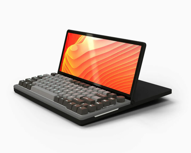 A compact KeyView 13" Touch computer with a built-in mechanical keyboard and a widescreen display showing an abstract orange pattern, all set against a white background.