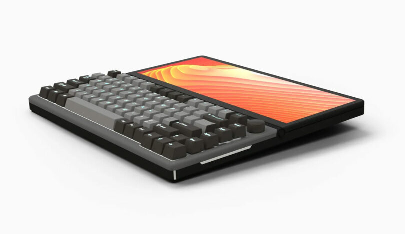 A compact KeyView 13" Touch computer with a built-in mechanical keyboard and a widescreen display showing an abstract orange pattern, all set against a white background.