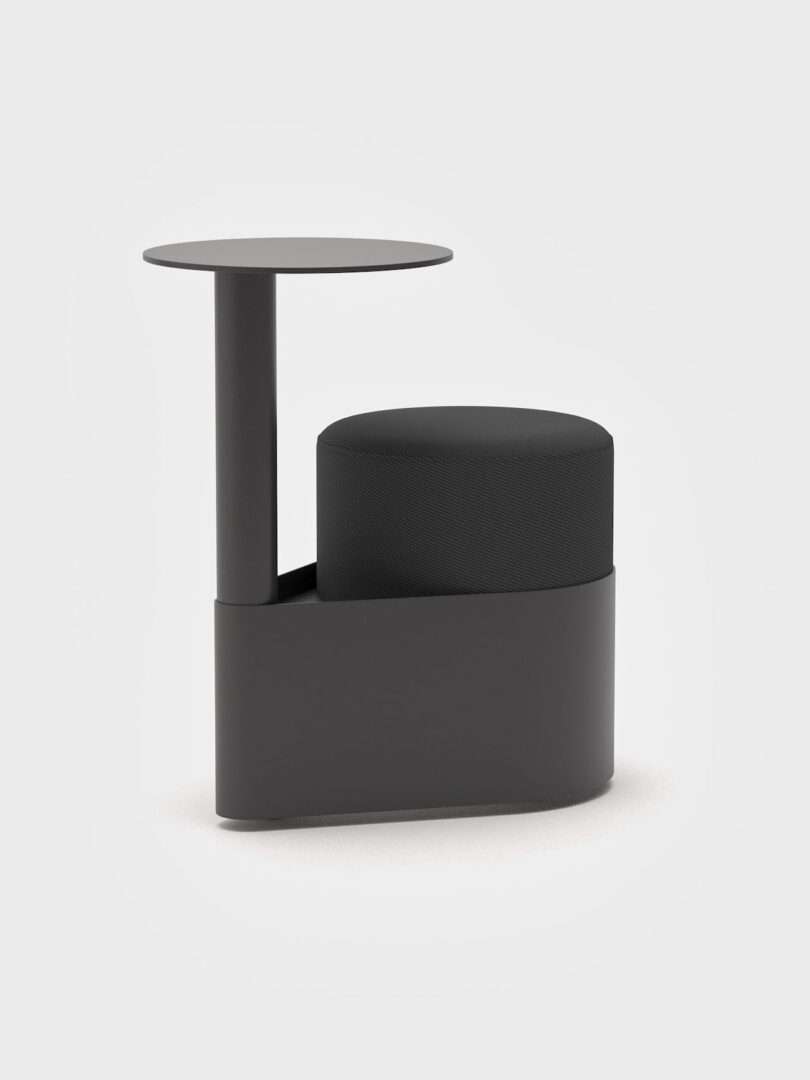 Modern black stool with a cylindrical cushioned seat and an attached round side table on a single pedestal base, set against a plain white background