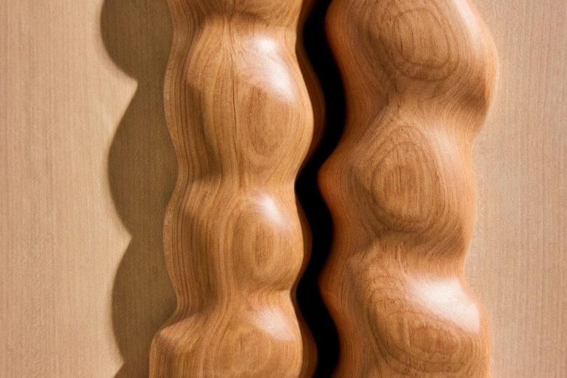 close up of A wooden cabinet featuring wavy, sculpted edges