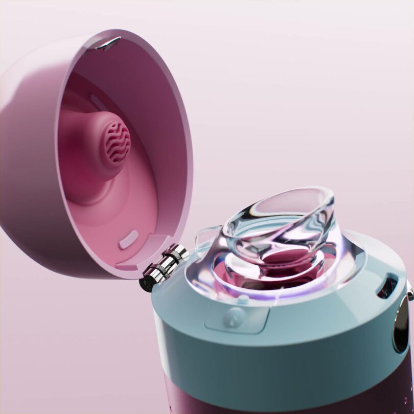 A close-up of an opened pink and white electronic device with a transparent, curved attachment and a hinged lid, set against a light pink background