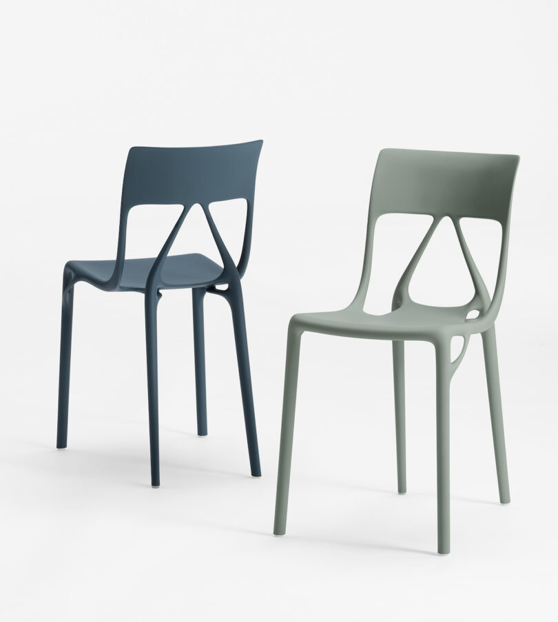 Two modern, minimalist chairs with geometric cut-out backs; one is dark blue, and the other is light gray-green, both set against a plain white background