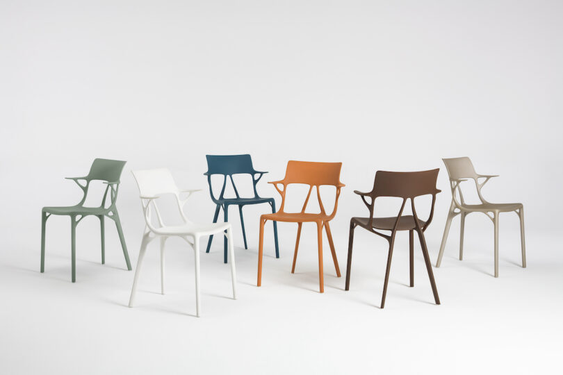 six modern plastic chairs in different colors are set against a plain white background