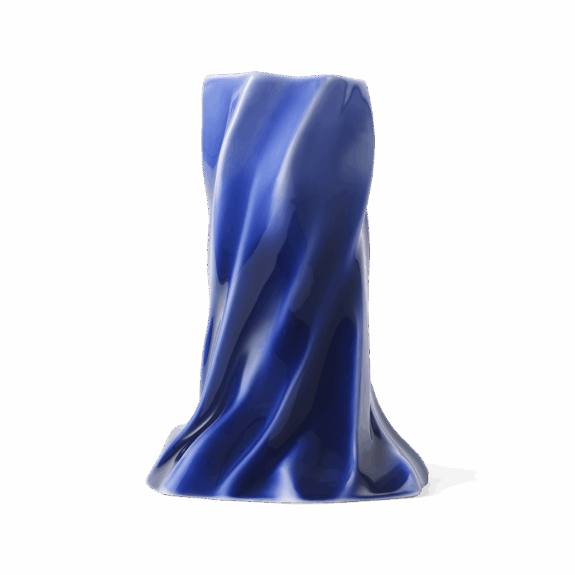 A shiny, deep blue sculpted vase with smooth, flowing folds resembling ocean waves, standing upright against a white background.