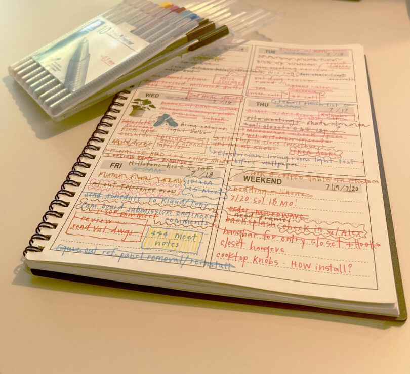 Open planner of transmission tiles with manuscripts in different colored pencils, many have crossed the set of colored finelers on the caravan in the creative spirit of Nicki Gitlin.