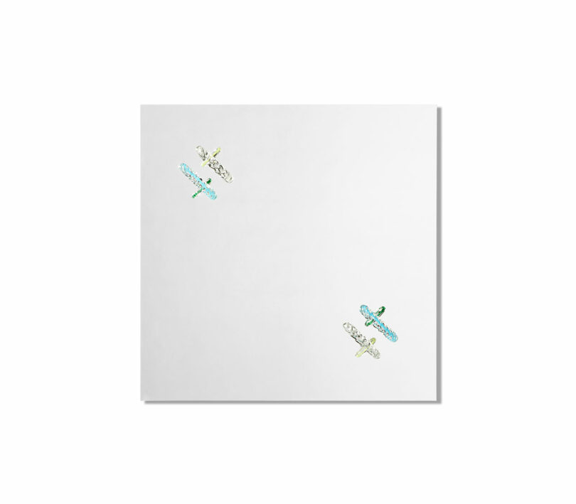 A white square sheet with two small dragonfly illustrations in the top left and bottom right corners.