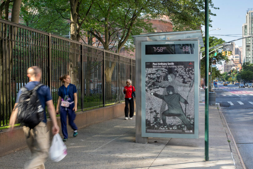 pedestrians noticing bus stop artwork