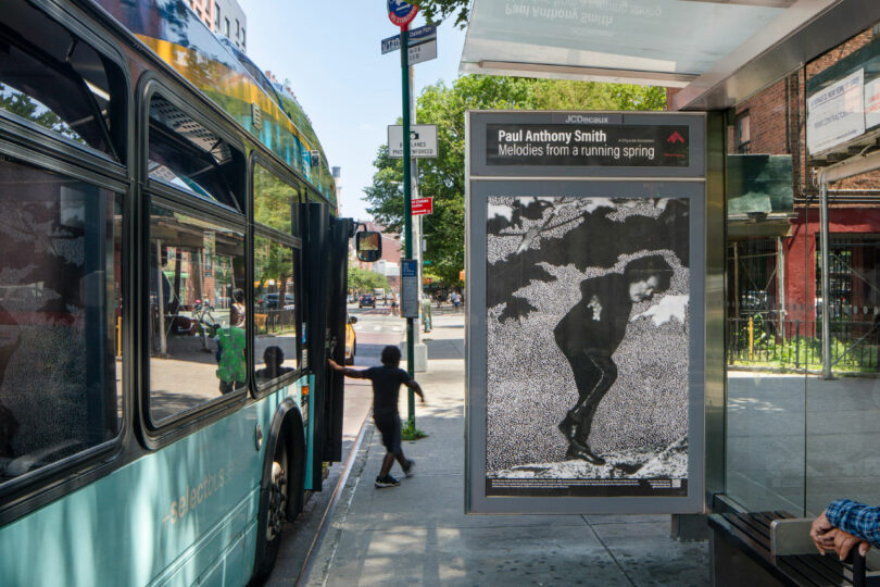 Child steps off bus near artwork