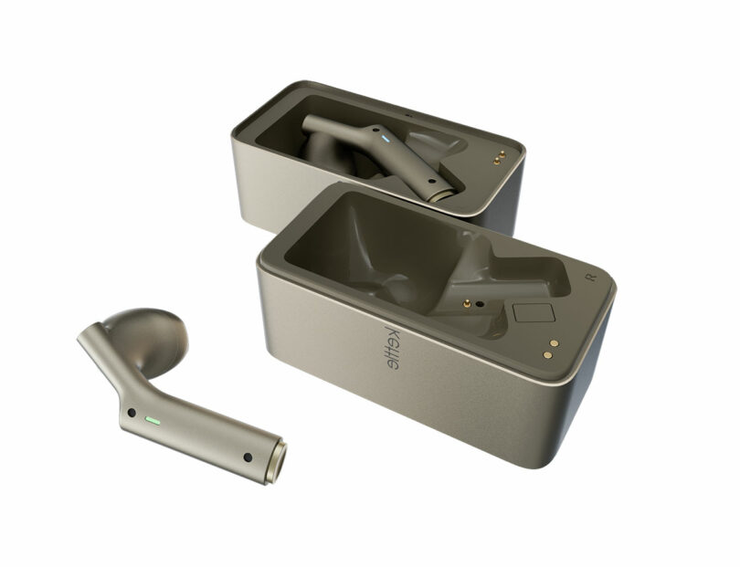 A pair of metallic wireless earbuds, with one earbud placed outside and the other inside an open charging case, both cases labeled "KEYS.
