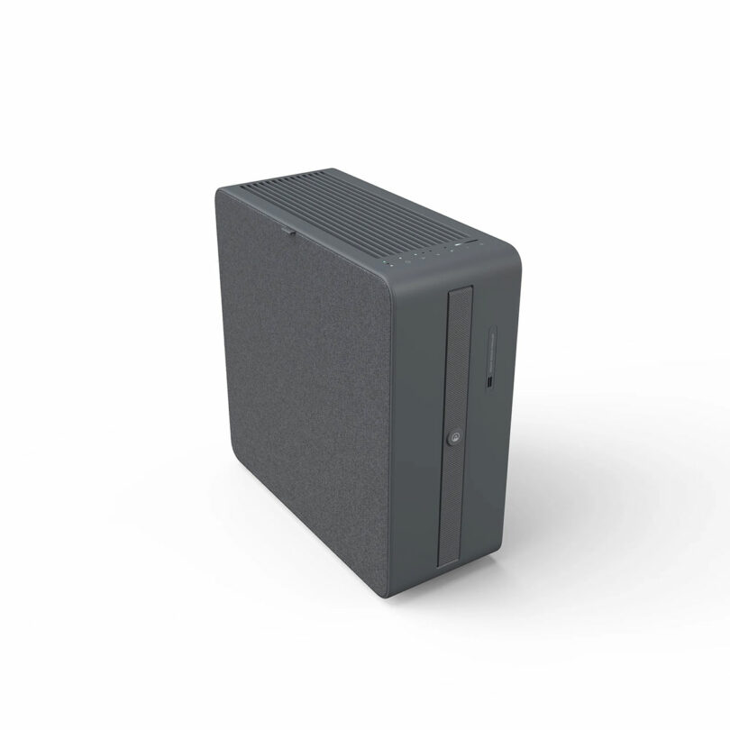 A gray desktop computer tower with a textured fabric panel on one side, vertical front panel with USB port, disc drive, and power button, set against a white background.