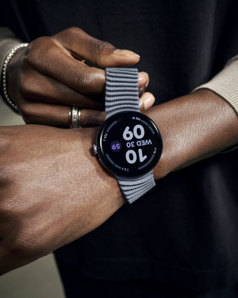A person wearing a gray-banded smartwatch displaying the time 10:09 and the date Wednesday 30 on their wrist.