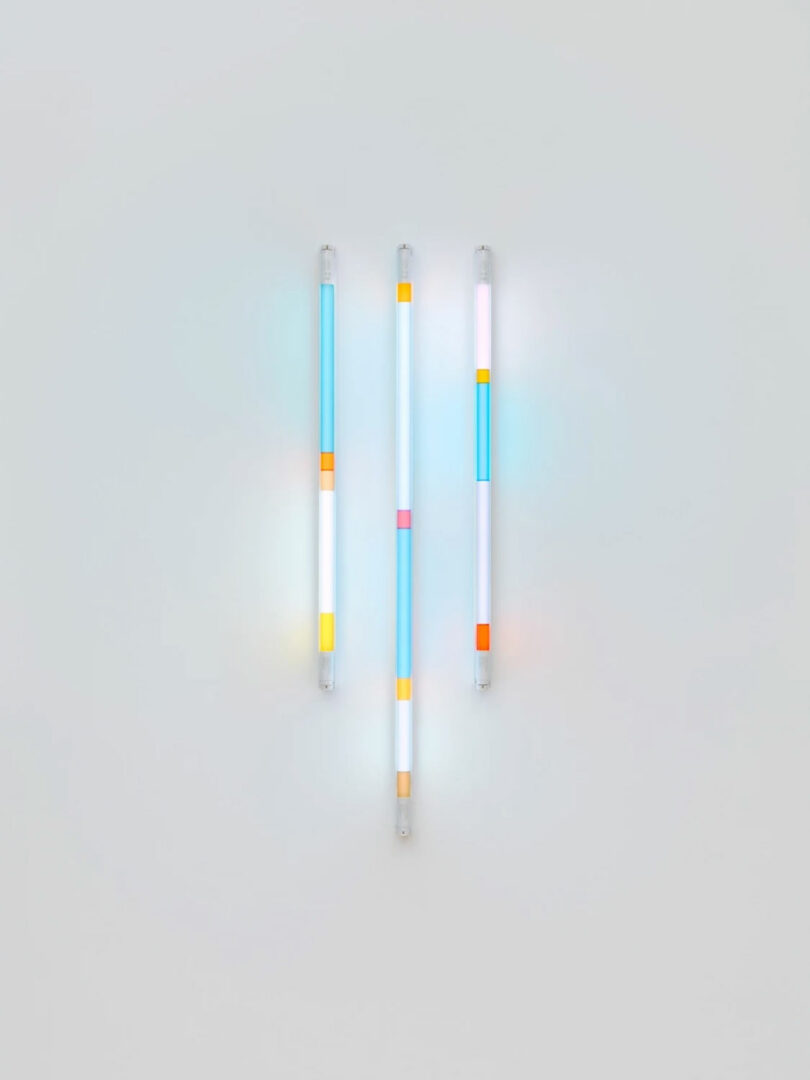 vertical light sculpture with sections of orange