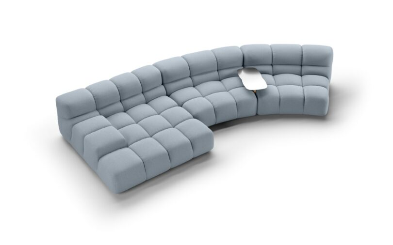 A modern, modular blue sectional sofa with tufted cushions and a built-in small wood and aluminum side table.