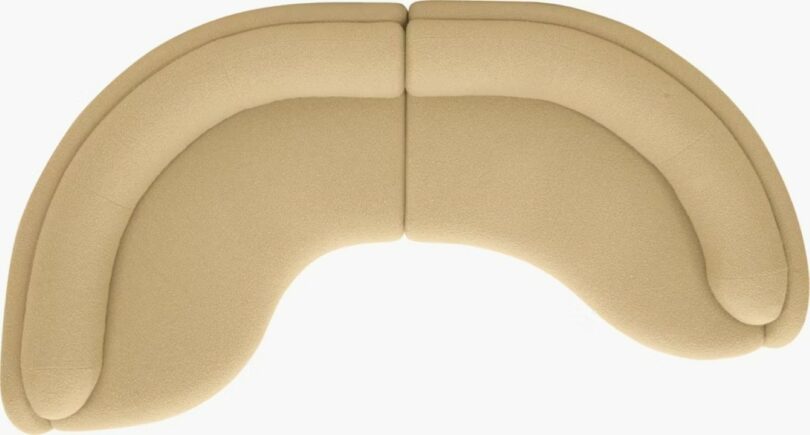 Top view of a beige, curved, two-piece sectional sofa with rounded edges and soft upholstery