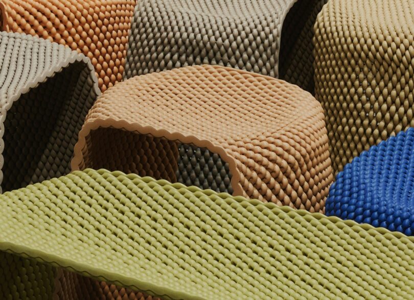 multiple woven stools in muted yellow, beige, and brown tones are arranged togethe