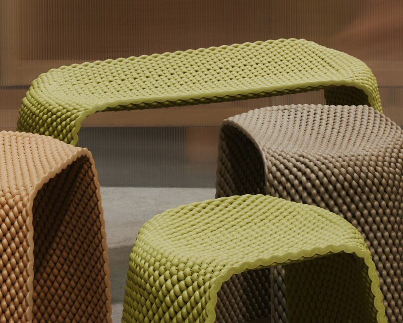 Four woven stools in muted yellomultiple woven stools in muted yellow, beige, and brown tones are arranged together