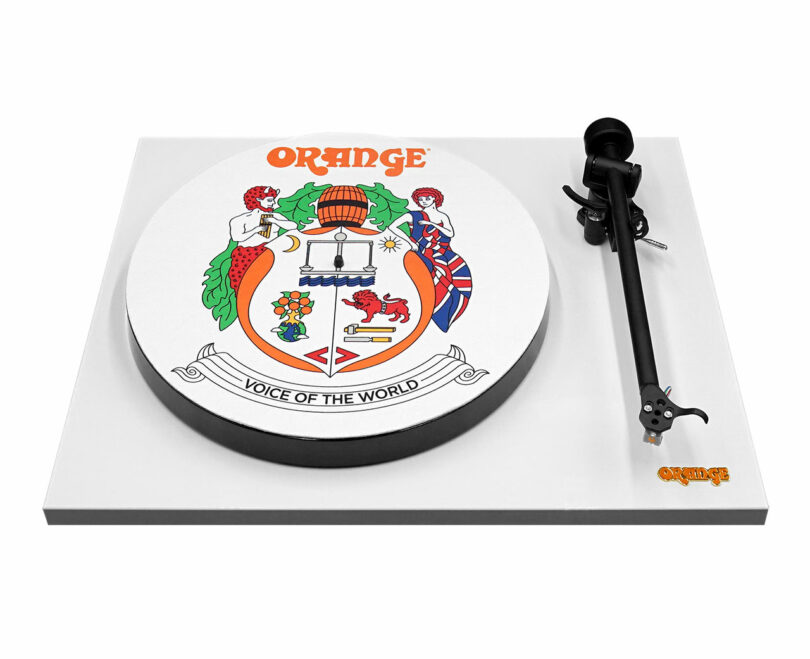 A white turntable featuring the Orange logo and a colorful crest with two mermaids, a barrel, flags, and the motto "Voice of the World" on the platter.