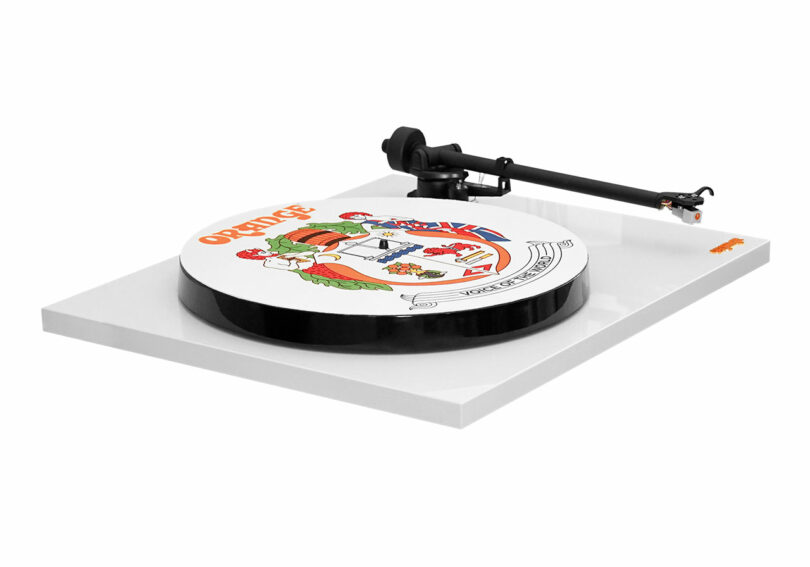 A white turntable featuring artwork from the Orange County Choppers logo on the platter.
