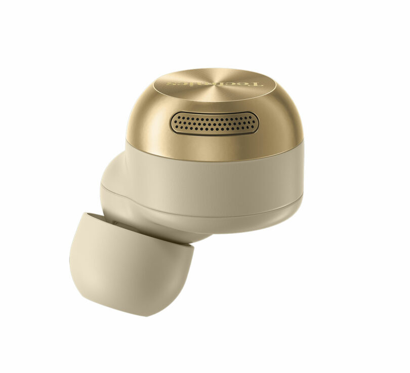 A single wireless earbud in gold and beige colors, shown on a white background.