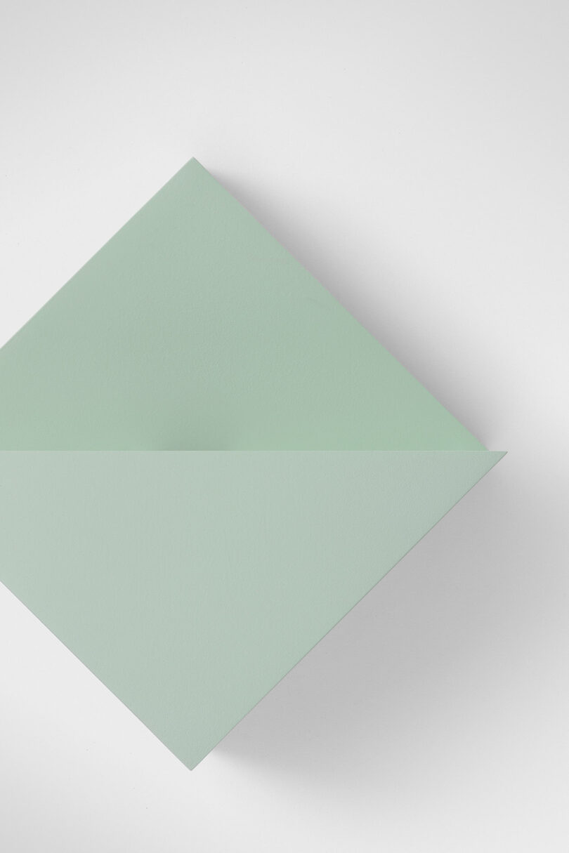 A close up of a geometric light fixture hanging on a wall.