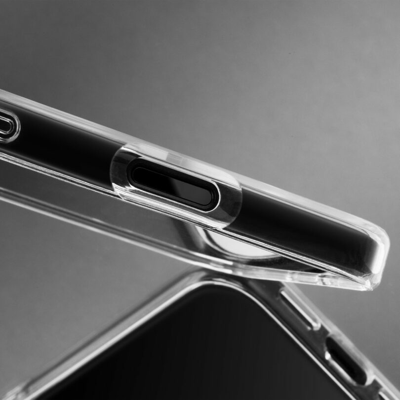 A close-up of a smartphone with a clear protective case, showing the camera cutout and part of the phone's edge against a gray background.